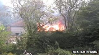 The fire seen through trees