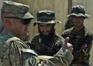 A US soldier (left) speaks to Afghan soldiers at Camp Hero in Kandahar Province, 10 September