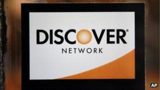 A Discover logo is adhered to a window at the entrance of a shop in Cambridge, Massachusetts 24 September 2012