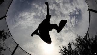 Boy jumping on trampoline