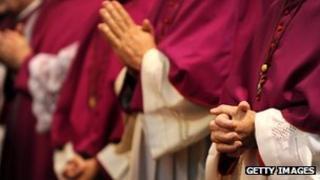 German bishops fold their hands as they attend the opening service for a plenary meeting of the German Conference of Catholic Bishops