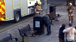 Man with head stuck in bin