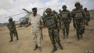 Brig Anthony Ngere (C), African Union Mission in Somalia (Amisom) Sector Two Commander and head of the Kenyan Contingent serving with Amisom, greets Brig Gen Ismail Sahardin Kaydsan of the Somali National Army (SNA) after arriving at Saa'moja, approximately 7km (4.3 miles) outside the Somali port city of Kismayo