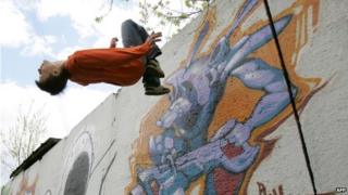 A Russian Parkour athlete performs a back-flip