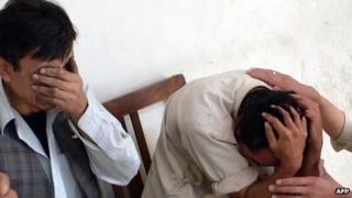 Shias mourn the killing of their relatives at a hospital following the attack by gunmen in Quetta