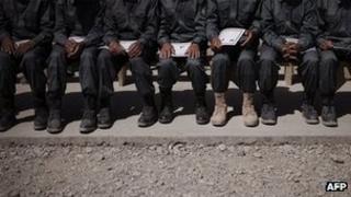 Afghan police graduates sitting on a bench