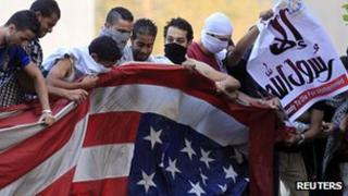Protester in Cairo destroy US flag. 11 Sept 2012