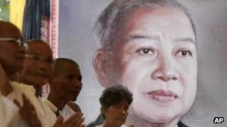 Cambodian Buddhist nuns in front of a picture of Norodom Sihanouk