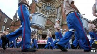 loyalist band marches past protesters