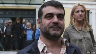 Greek editor Costas Vaxevanis (C) leaves a prosecutor's office in Athens October 28