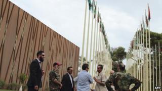 Security members meet spokesmen representing ex-revolutionary militia groups in front of the General National Congress building in Tripoli, November 1