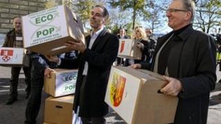 Philippe Roch, right, helps hand in the petition to Swiss Chancellery in Bern