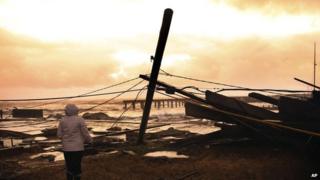 A woman surveys the damage near her home in Atlantic City, New Jersery