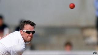 England cricketer Graeme Swann bowls on the first day of a three-day practice match between India A and England at the Cricket Club of India (CCI) grounds in Mumbai on October 30, 2012
