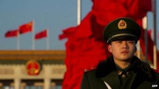 A paramilitary policeman stands before the Great Hall of the People before the closing ceremony of the Communist Party Congress in Beijing early on 14 November 2012