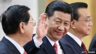 Members of the new Politburo Standing Committee Xi Jinping (C), Li Keqiang (R) and Zhang Dejiang (L) greet the media at the Great Hall of the People on November 15, 2012 in Beijing, China.