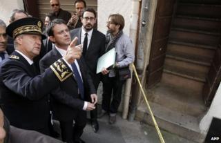 French Interior Minister Manuel Valls listens to South Corsica's Prefect, Patrick Strzoda , at the scene of Jacques Nacer's murder in Ajaccio, 15 November