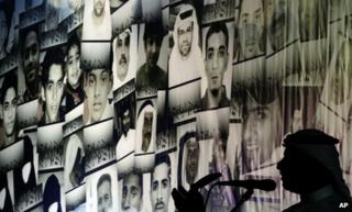 Hussein Niema addresses a pro-democracy rally in Muqsha, in front of pictures of those killed in Bahrain since February 2011