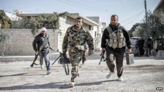 Rebels defending the town run towards a forward fighting position in Maraat al-Numan November 20, 2012