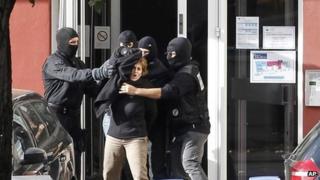 Izaskun Lesaka, centre, surrounded by French Police officers, screams as she leaves the hotel where she was arrested with another suspected member of Eta