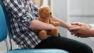 Doctor holding patient's hand