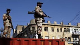 Pakistani paramilitary soldiers stand guard during an Ashura ceremony to mark the death of Hussein, the grandson of Prophet Mohammad in Karachi November 25, 2012
