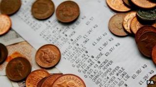 Supermarket till receipt with coins