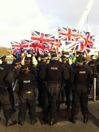 Loyalists carrying union flags marched over the Londonderry Peace Bridge