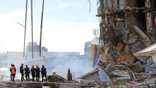 Rescuers at the smoking ruins of the CTV building on 24 February 2011