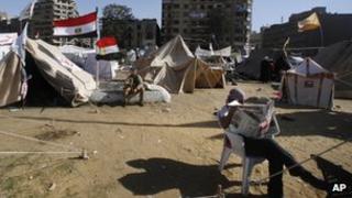 A man reading in front of a protest tent in Tahrir Square, 10 December 2012