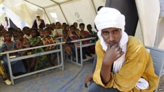 Malian refugee children sit on December 7, 2012 under a tent that serves as a classroom in the Goudebou in Burkina Faso