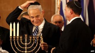 Israeli PM Benjamin Netanyahu lights candles to mark Hanukah during an event for foreign journalists in Jerusalem on 10/12/12