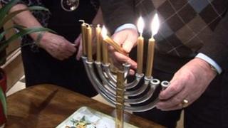 Menorah candles being lit