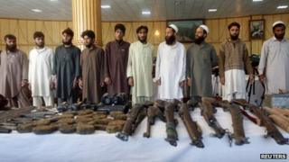 Taliban insurgents and their weapons confiscated by Afghan joint forces during an operation are presented to the media in Jalalabad province