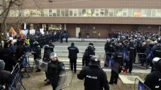The police create a cordon between the supporters of the conservative government, left and the supporters of the opposition, right, who are protesting "pro" and "against " the national budget, in Skopje, Macedonia