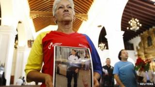 Supporters pray for Mr Chavez at a Mass in Caracas, December 24