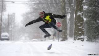 Teenager snowboards down road in Pennsylvania