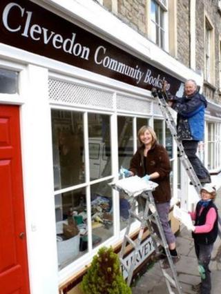 Painting the sign on the new bookshop