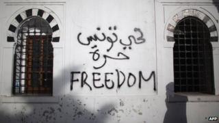 File photo of graffiti at a government building during a protest in Tunisia on 21 January 2011 a week after former President Zine al-Abidine Ben Al fled