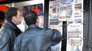Algerian men look at national newspapers headlining the terrorist attack and kidnapping in Amenas at a news stand in Algiers, Thursday, Jan. 17, 2013.