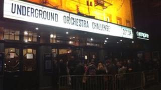 People queuing to go into the Underground orchestra concert