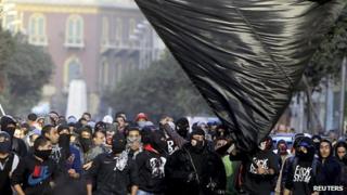 Members of the Black Bloc are seen during the protest in Tahrir Square in Cairo on 25 January