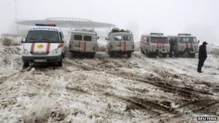 Emergencies Ministry vehicles and ambulances are parked near the site of the plane crash outside Almaty January 29, 2013.