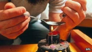 A heroin user prepares a does of the drug (file image)