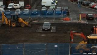 The mercedes sits on an island of asphalt