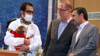 President Mahmoud Ahmadinejad (right) with the monkey that went into space in Tehran on 4/2/13