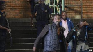 Alleged members of he Union of Nationalists for Renewal outside a court in Pretoria, South Africa - 7 February 2013