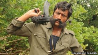 Actor Kishore playing the role of Veerappan