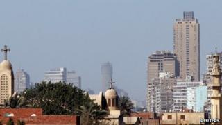 A mosque's minaret beside a Coptic church in Cairo (23 February 2013)