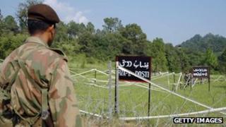 A Pakistani soldier watches Indian soldiers at the Tattapani-Mendher crossing point on the Line of Control, some 35km from Kotli, in Pakistani administered Kashmir, 09 September 2006